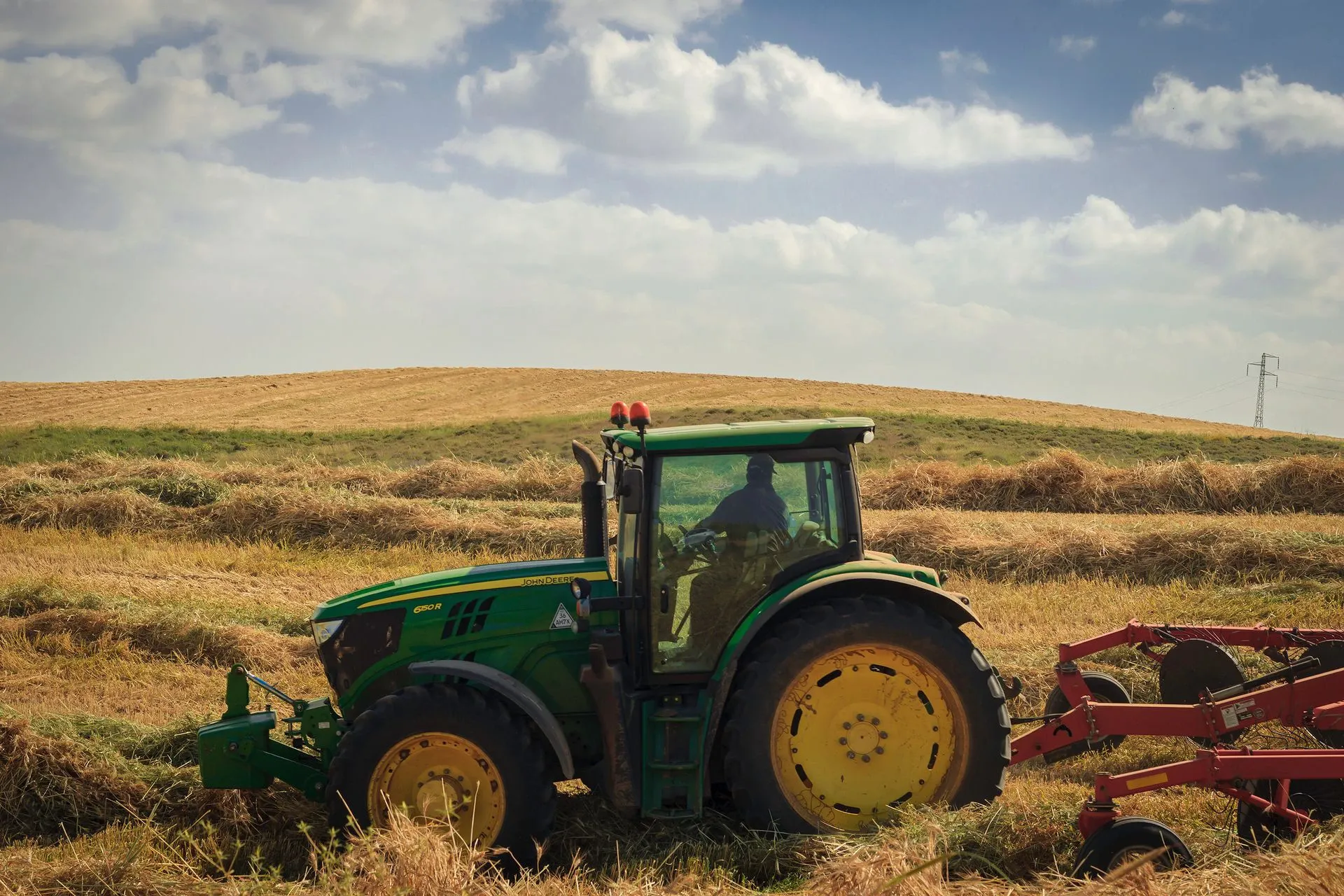 Farrelly Bros tractor working a field.