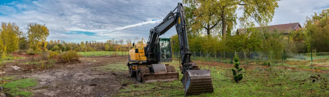 Excavator working a cleared site.