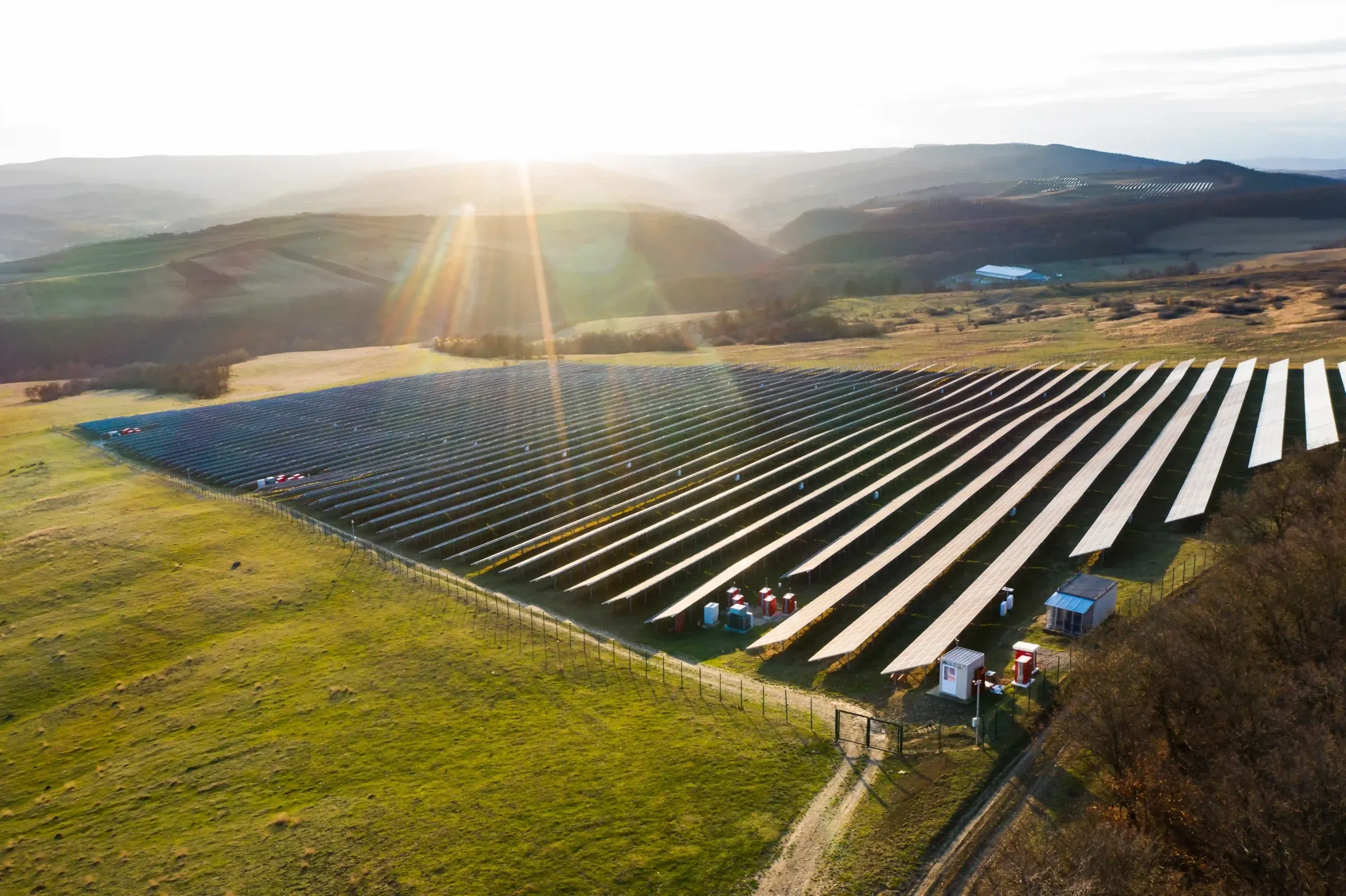 Aerial view of a solar farm across open land.
